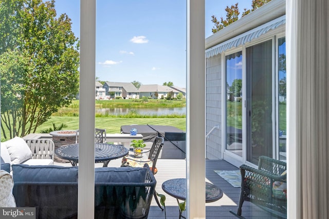 doorway to outside with a water view