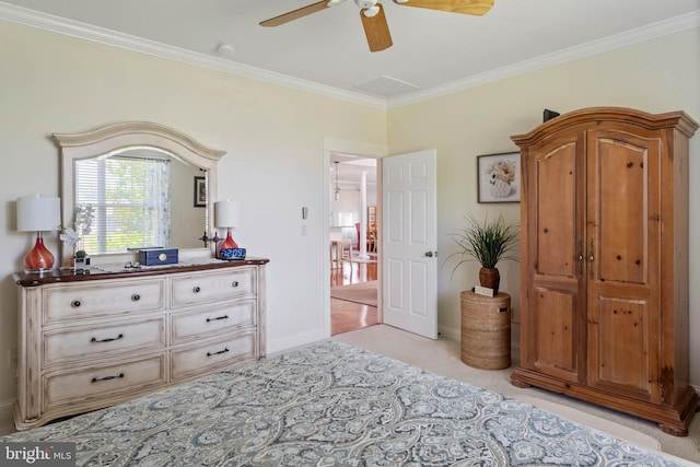 bedroom featuring crown molding, ceiling fan, and light colored carpet