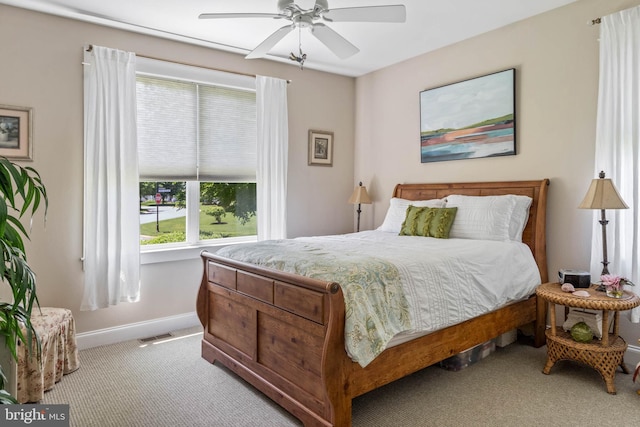 bedroom with ceiling fan and light colored carpet