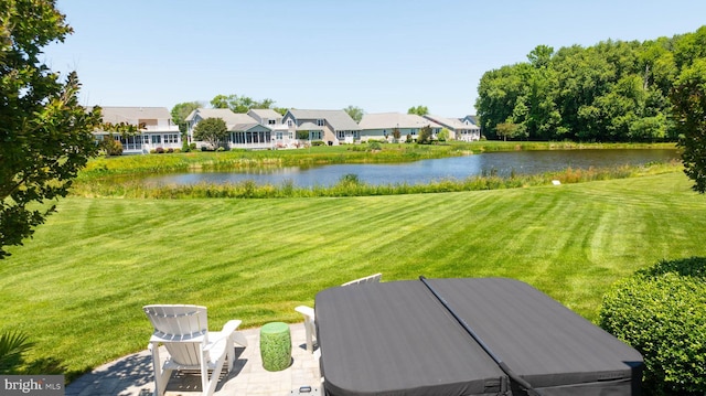 view of yard featuring a water view and a patio area