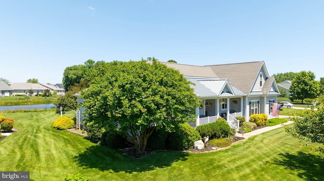 view of property exterior featuring a water view, a porch, and a lawn