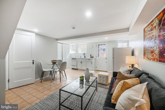 living room with light tile patterned floors, baseboards, and recessed lighting