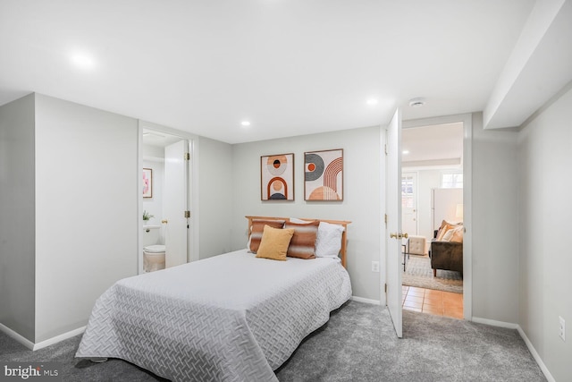 tiled bedroom featuring carpet flooring, recessed lighting, ensuite bath, and baseboards