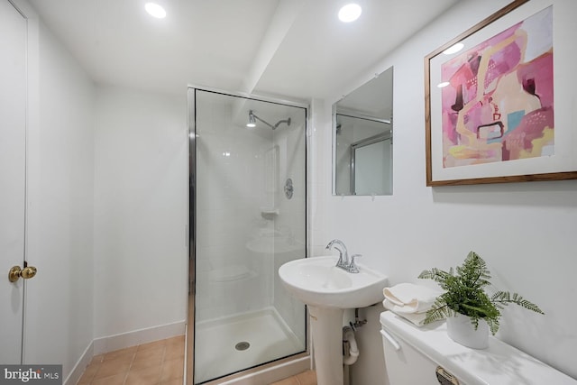 bathroom featuring toilet, a sink, recessed lighting, a shower stall, and tile patterned flooring