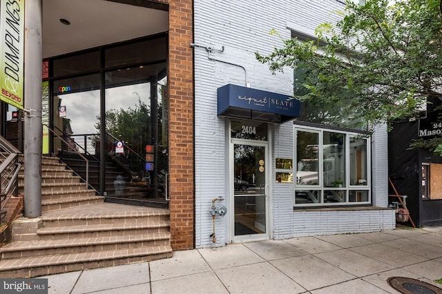 doorway to property featuring brick siding