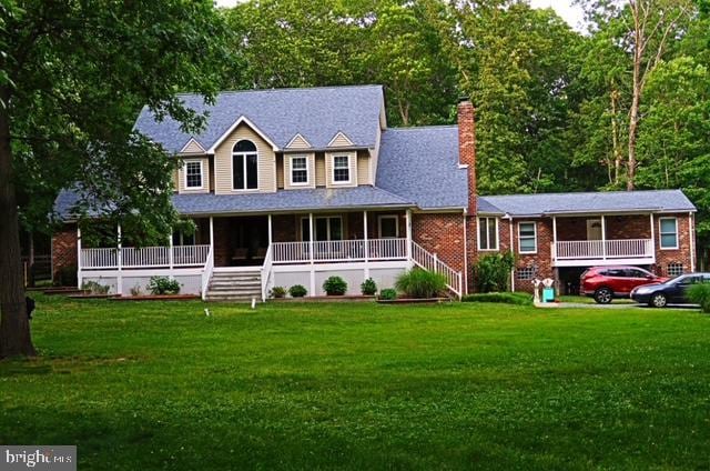 view of front of house with covered porch and a front yard