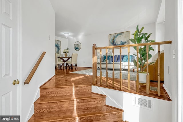 stairway with hardwood / wood-style flooring