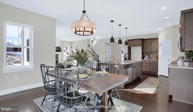 dining space with sink and dark wood-type flooring