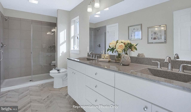 bathroom featuring vanity, toilet, and an enclosed shower