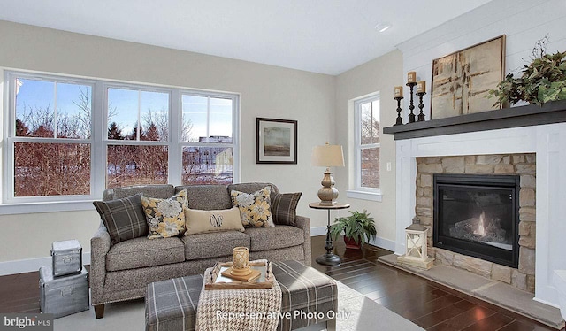 living room featuring a fireplace, dark hardwood / wood-style flooring, and a healthy amount of sunlight