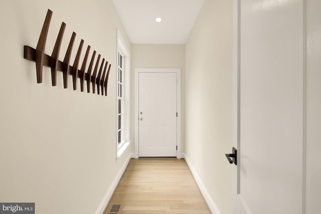 corridor with light hardwood / wood-style flooring