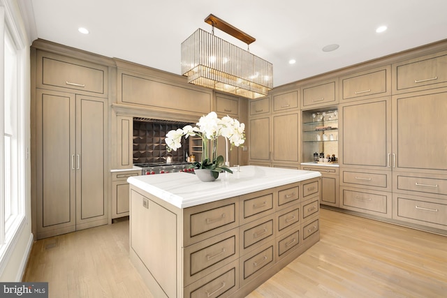 interior space with pendant lighting, a center island, and light hardwood / wood-style floors