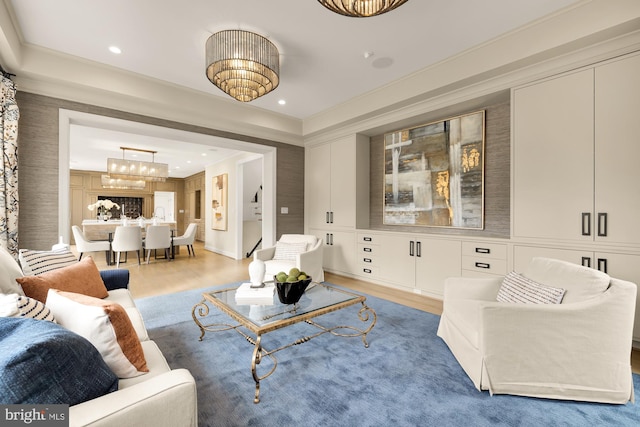 living room with light hardwood / wood-style floors and crown molding