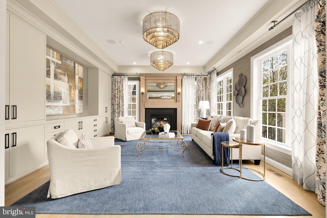 living room with wood-type flooring and crown molding