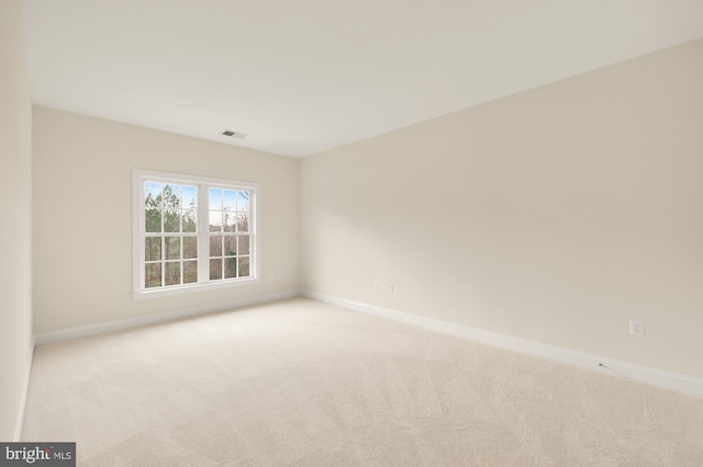 spare room with light colored carpet