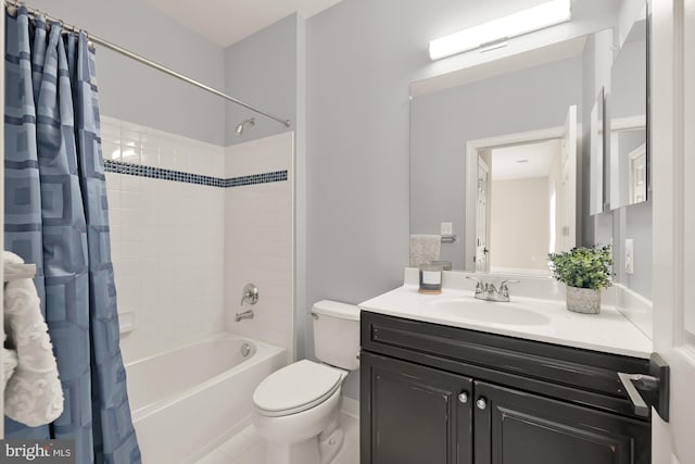 full bathroom featuring tile patterned floors, shower / bath combo with shower curtain, vanity, and toilet