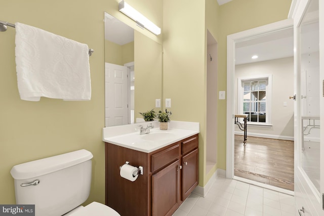 bathroom with tile patterned flooring, vanity, and toilet