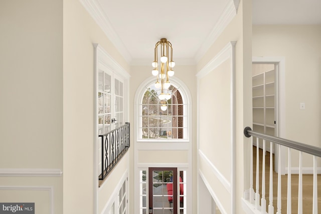 interior space featuring a chandelier and ornamental molding