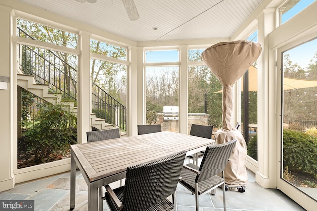 sunroom featuring ceiling fan and a healthy amount of sunlight