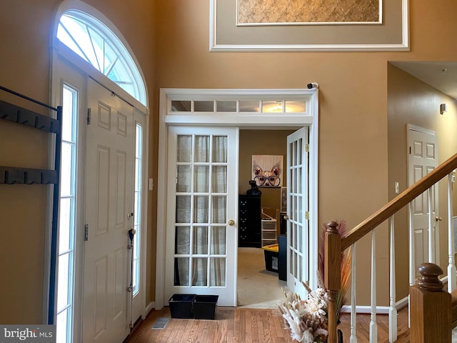 entrance foyer featuring hardwood / wood-style floors and french doors