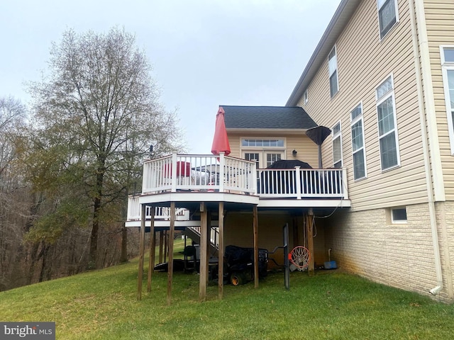 back of house featuring a wooden deck and a yard