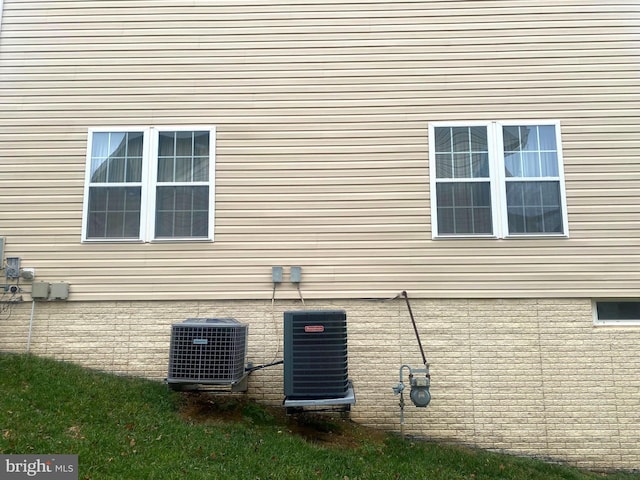 view of side of home with central AC unit