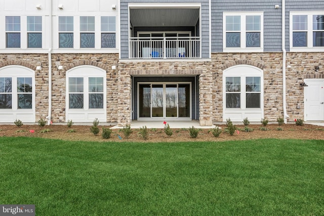 doorway to property featuring a lawn