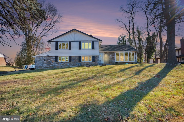 split level home featuring a lawn