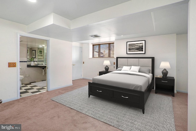 carpeted bedroom featuring ensuite bathroom