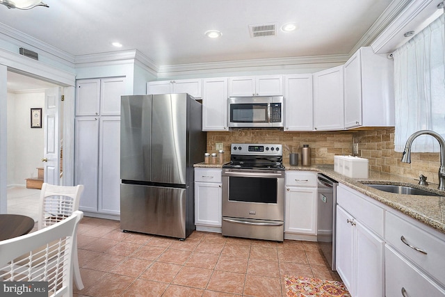 kitchen featuring white cabinets, stainless steel appliances, and sink