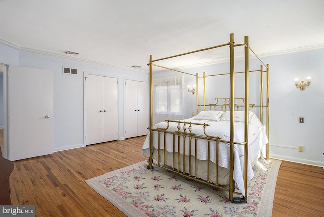 bedroom featuring hardwood / wood-style floors and ornamental molding