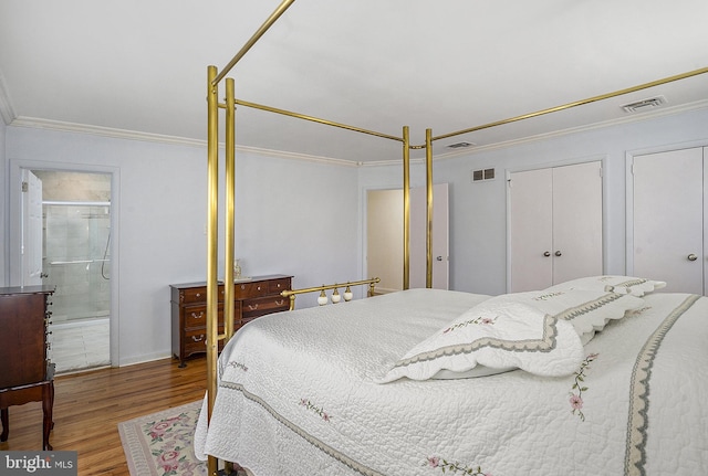 bedroom with wood-type flooring, ensuite bathroom, and ornamental molding