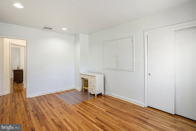 unfurnished bedroom with hardwood / wood-style flooring