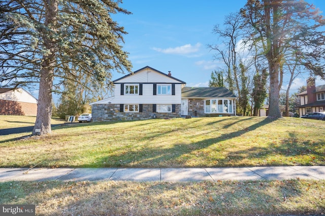 tri-level home with a front yard