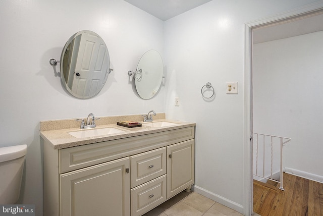 bathroom featuring vanity, hardwood / wood-style flooring, and toilet