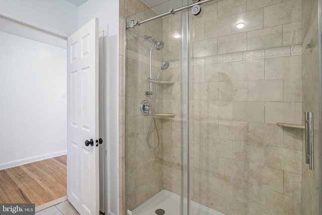 bathroom featuring hardwood / wood-style floors and an enclosed shower