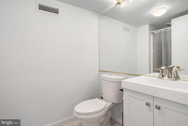 bathroom featuring tile patterned flooring, vanity, curtained shower, and toilet