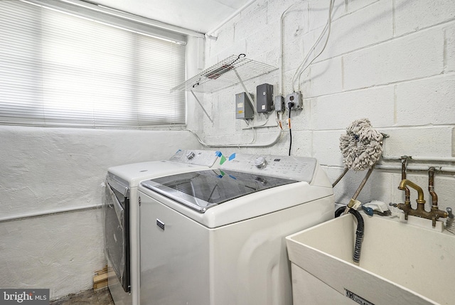 washroom featuring washer and clothes dryer and sink