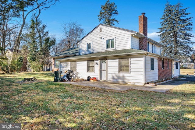 rear view of house with a patio area and a yard