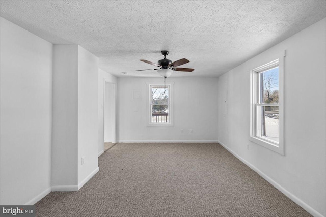 unfurnished room with ceiling fan, carpet, and a textured ceiling