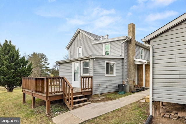 rear view of property featuring a deck