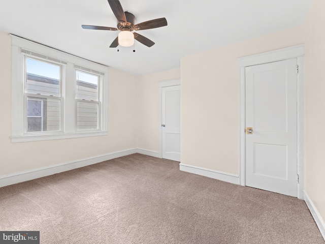 carpeted empty room with ceiling fan