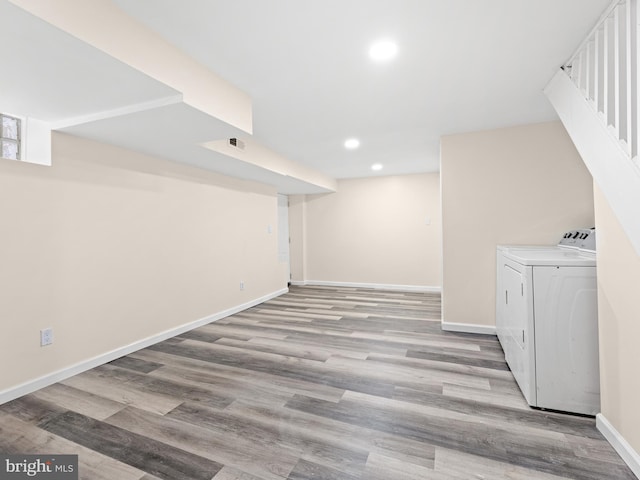 basement featuring light hardwood / wood-style floors and independent washer and dryer