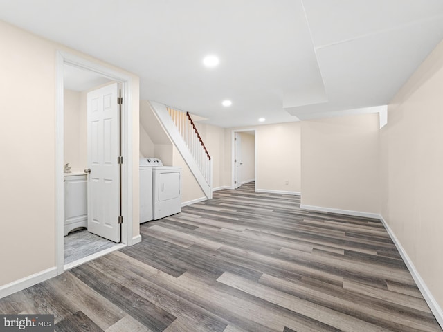 basement with hardwood / wood-style floors and washing machine and clothes dryer