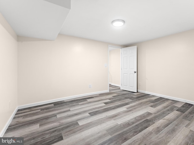 empty room with hardwood / wood-style flooring