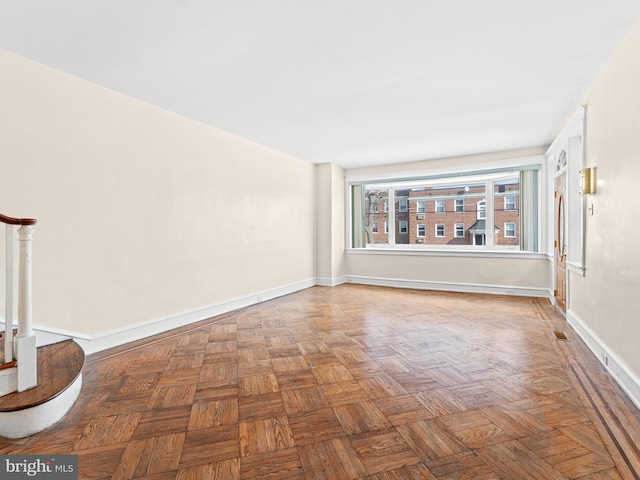 empty room with parquet flooring