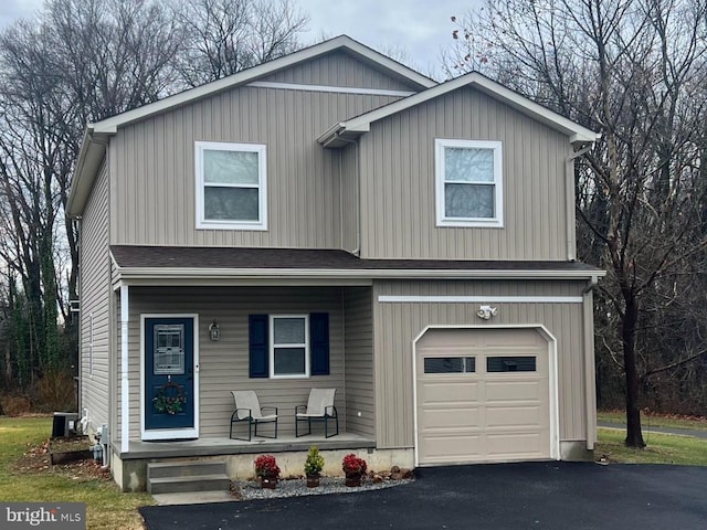 front of property with a porch and a garage