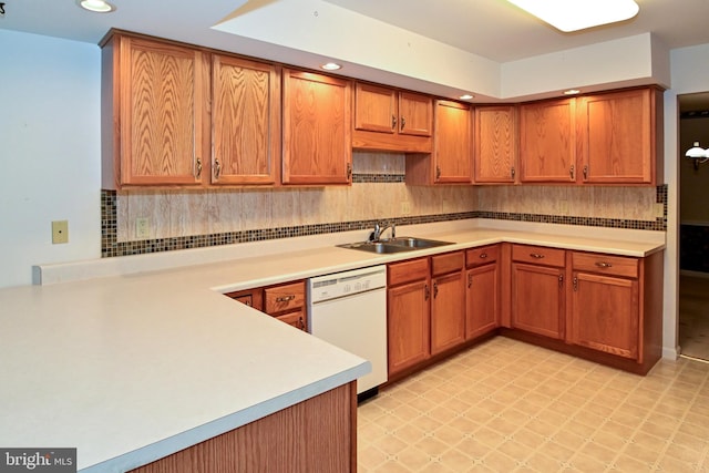 kitchen featuring tasteful backsplash, sink, and white dishwasher