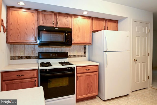 kitchen featuring decorative backsplash and white appliances