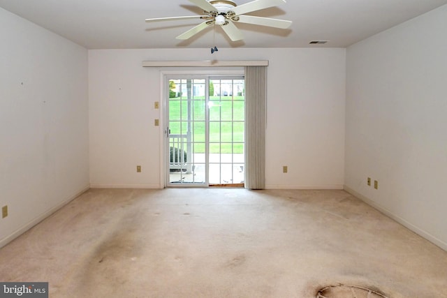 carpeted spare room with ceiling fan